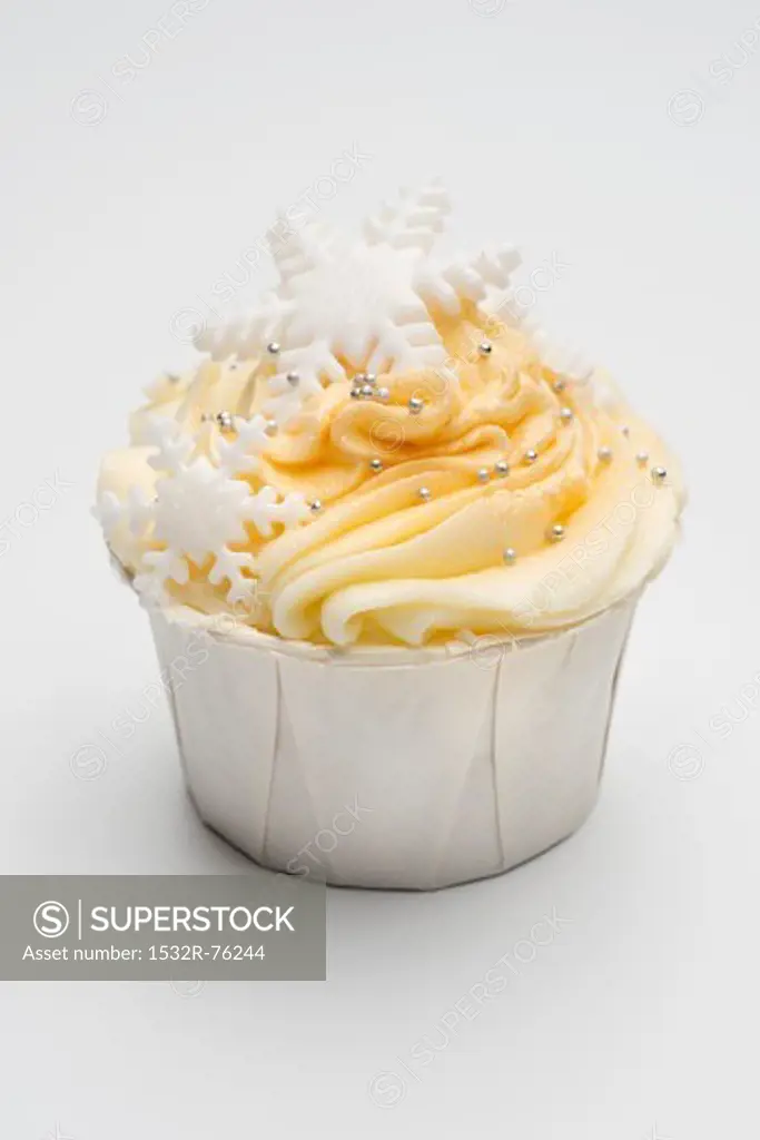 A cupcake decorated with yellow icing, silver balls and snowflakes, 10/30/2013