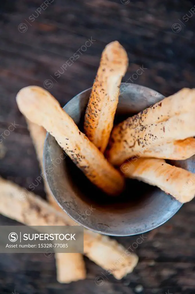 Poppy seed breadsticks in a metal container (view from above), 11/30/2013