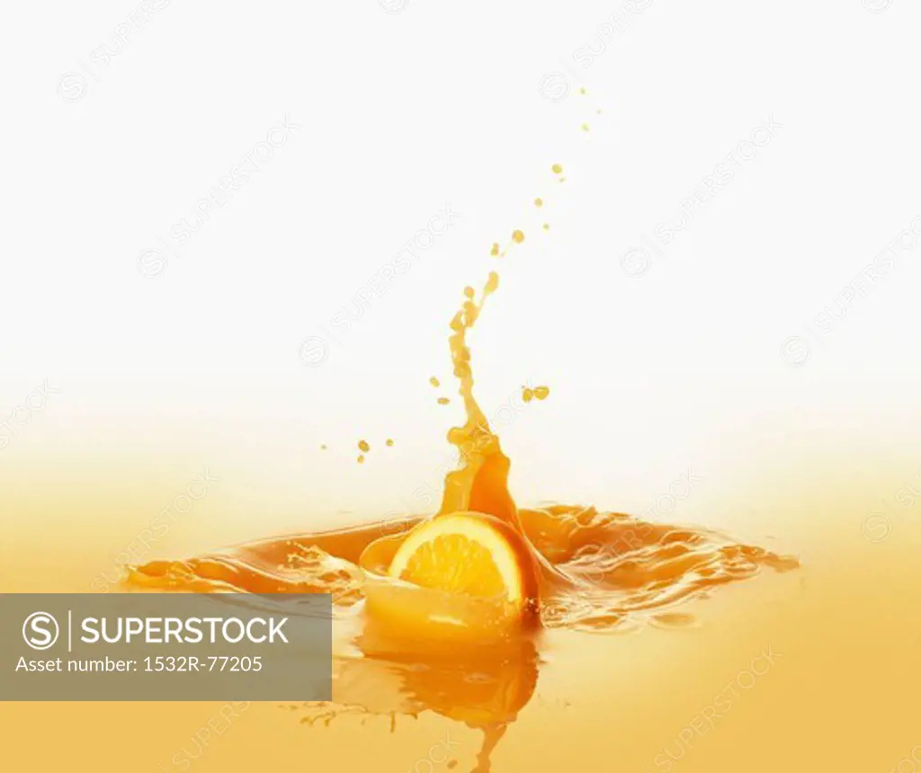 Orange slice falling into orange juice, 12/9/2013