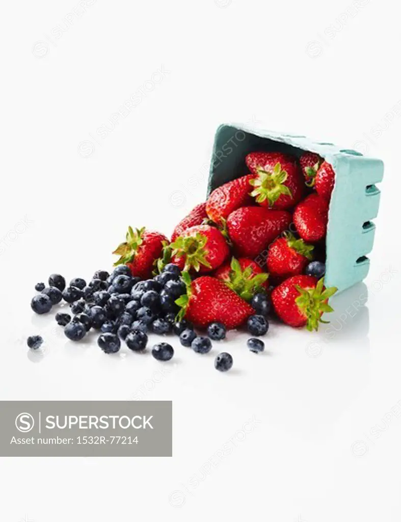 Fresh Strawberries and Blueberries Spilling from a Carton, 12/9/2013
