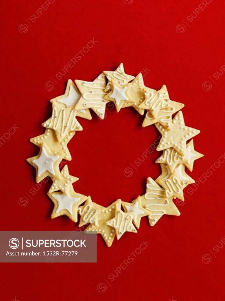 Wreath made of star cookies in front of a red background, 12/9/2013