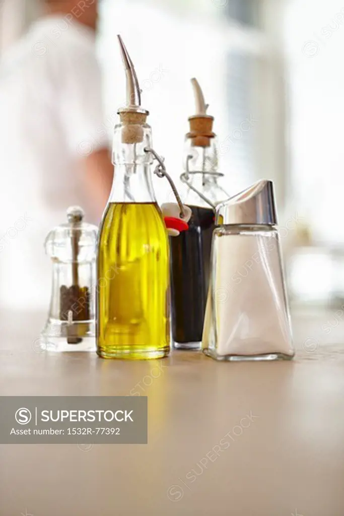 Vinegar and oil dispensers, a pepper mill and a sugar caster on a restaurant table, 12/17/2013