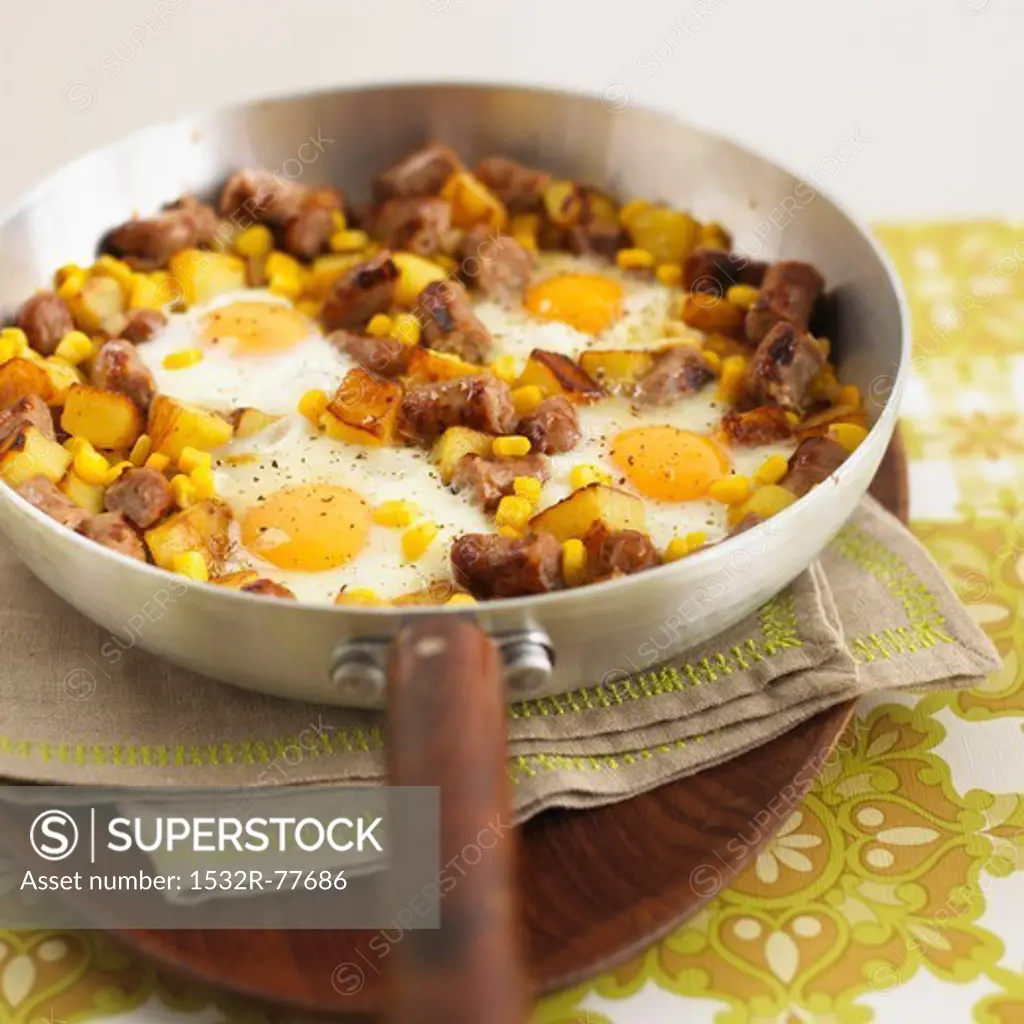 Hash browns with pieces of sausage, sweetcorn and fried eggs, 1/6/2014
