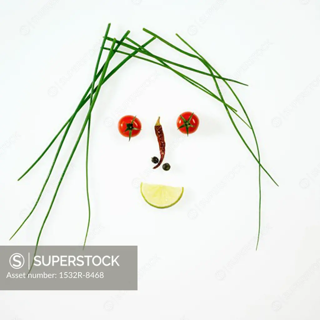 Face made from chives, vegetables and lime