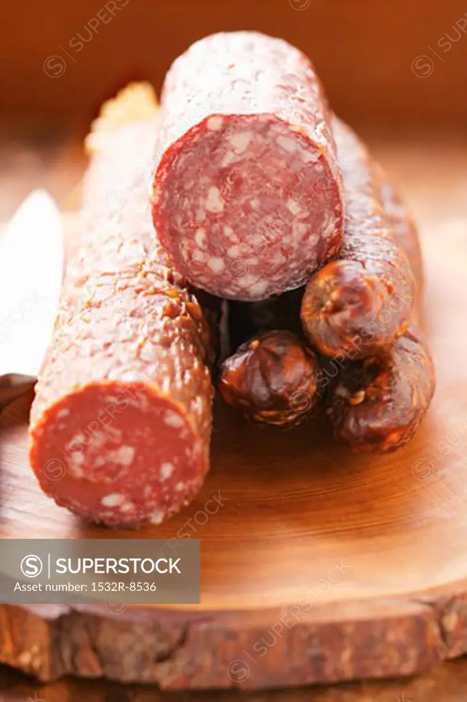 Various venison sausages on wooden plate
