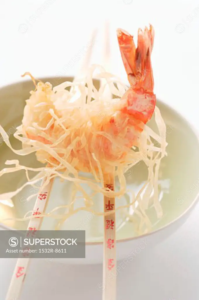 King prawn, fried in rice noodles, on chopsticks