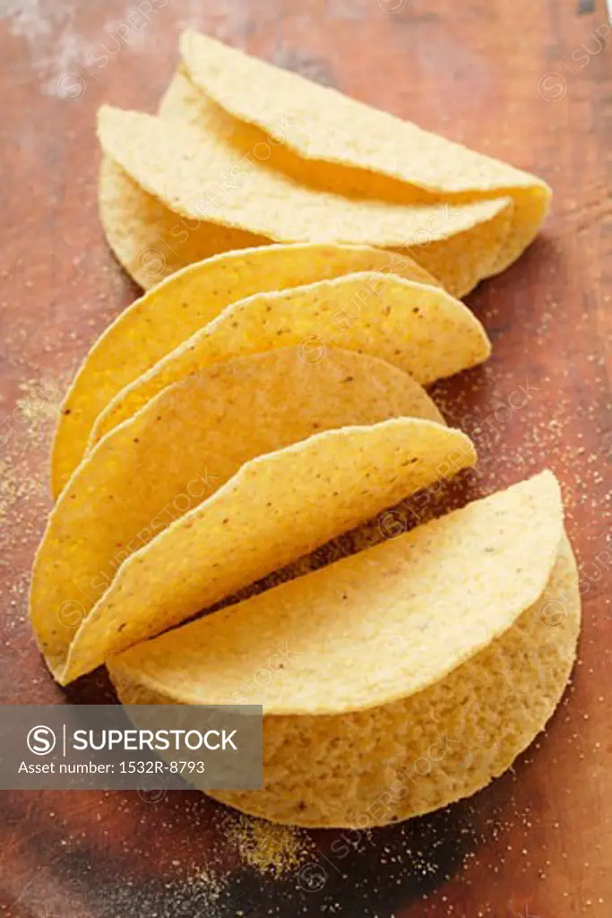 Taco shells on wooden background