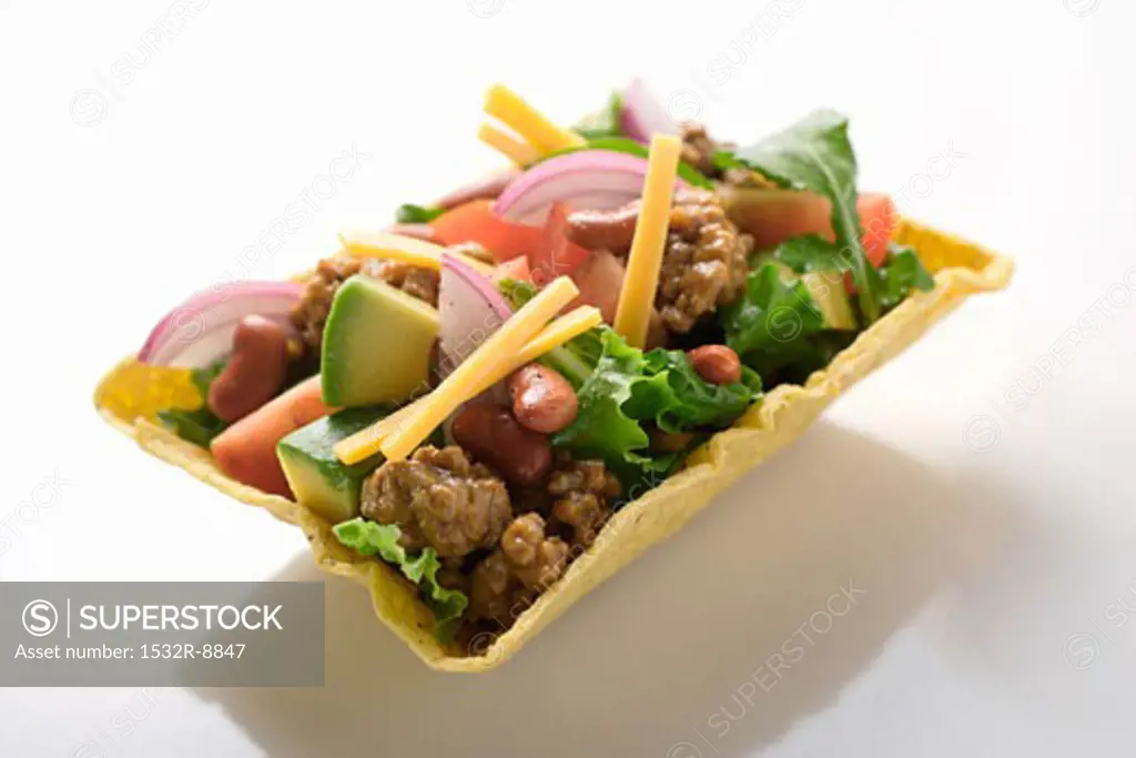 Salad with mince, vegetables, cheese in taco shell (Mexico)