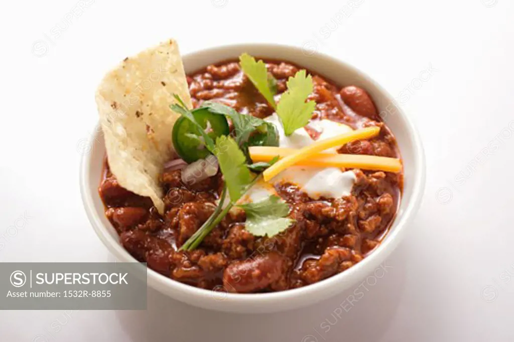 Chili con carne with cheese, sour cream and tortilla chips