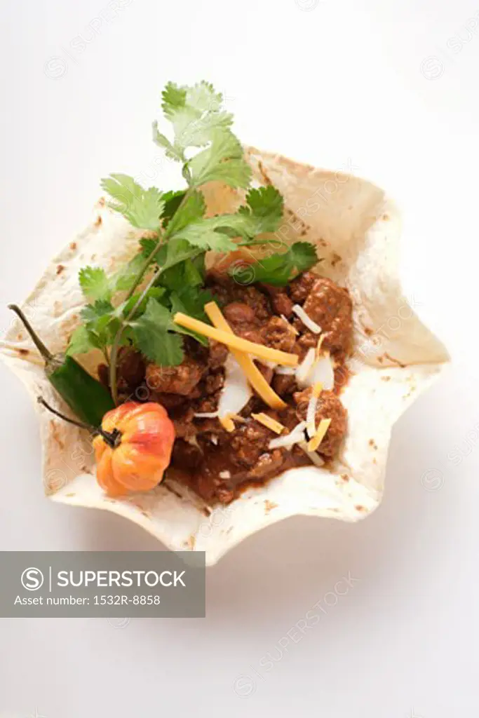 Chili con carne with cheese and sour cream in tortilla shell