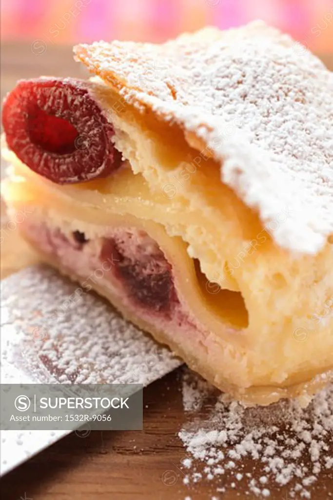 Piece of cherry strudel with icing sugar