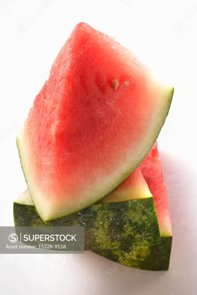 Three watermelon wedges in a pile