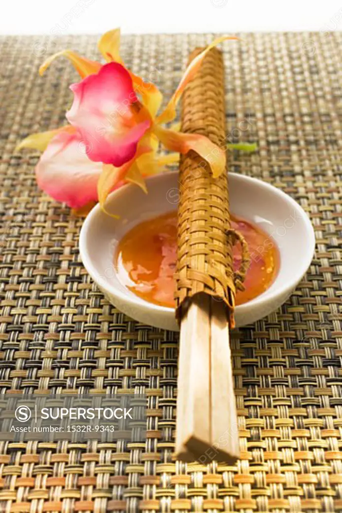 Sweet and sour sauce, flower and chopsticks