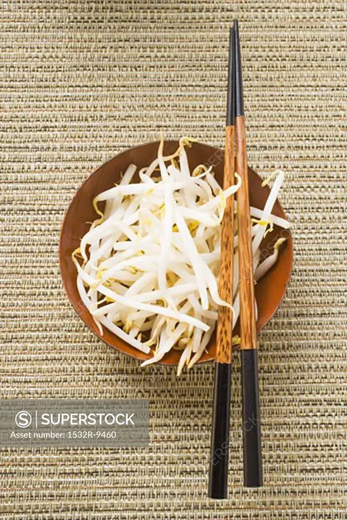 Fresh soya sprouts in bowl with chopsticks