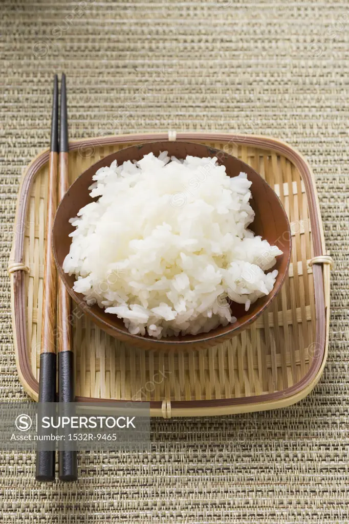 Bowl of rice and chopsticks on tray