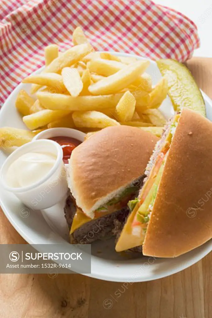 Cheeseburger, chips, mayonnaise, ketchup on plate