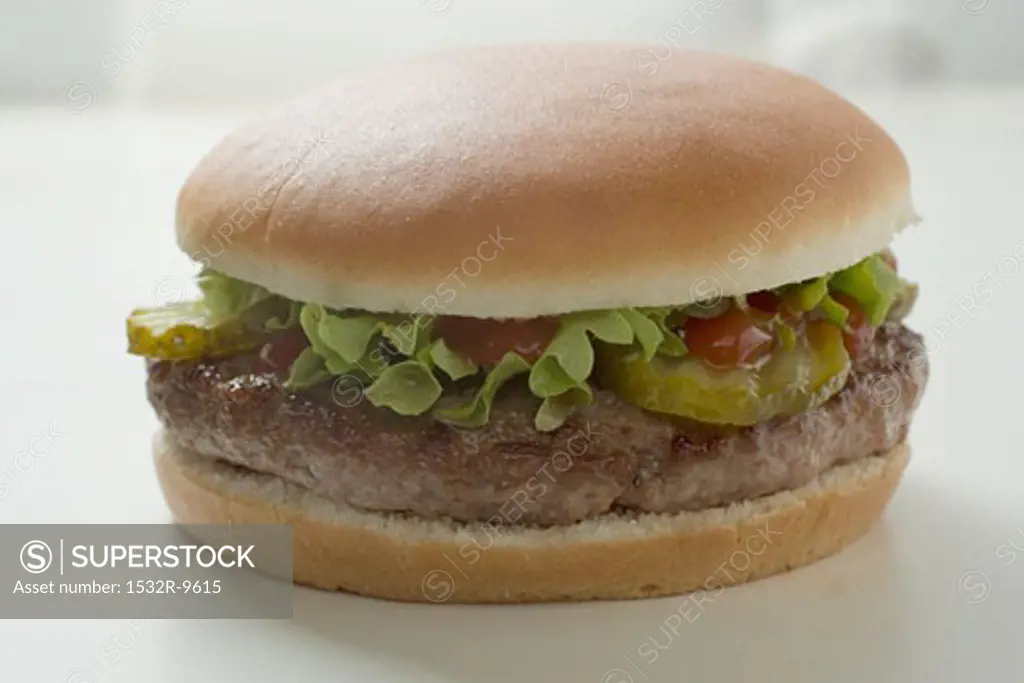 Hamburger with gherkin, lettuce and ketchup