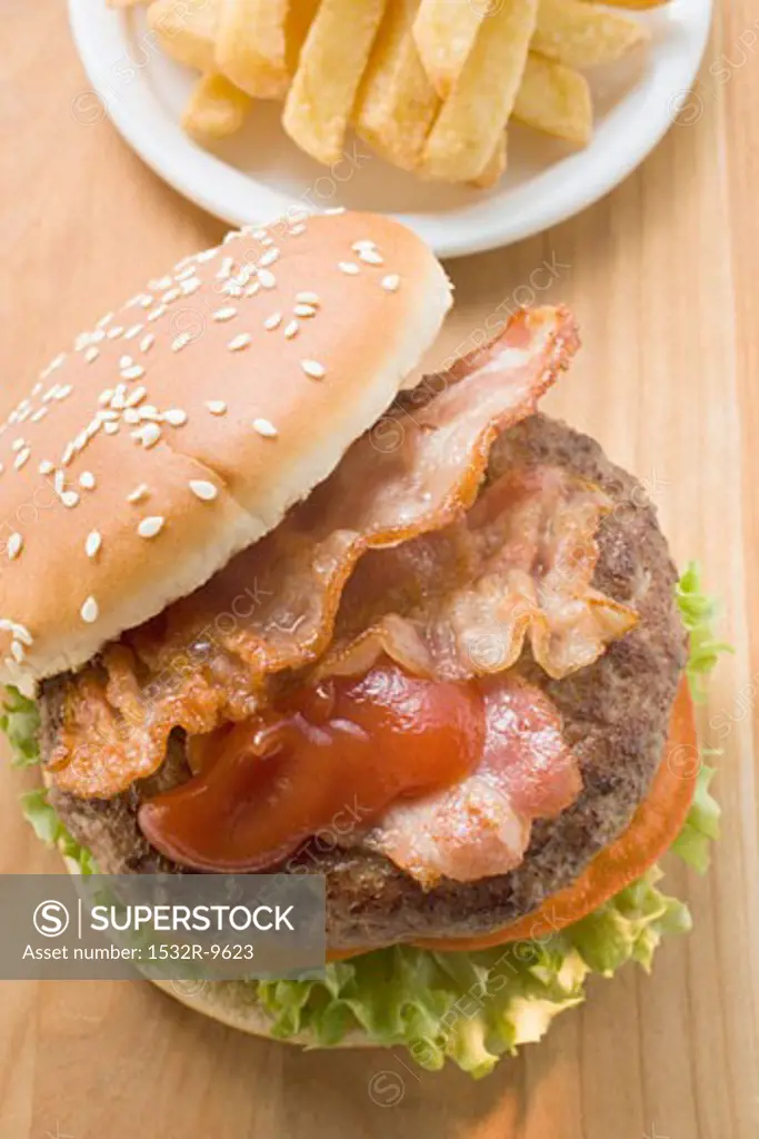 Hamburger with bacon, ketchup and chips