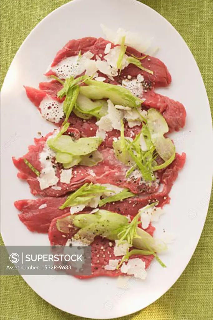 Beef carpaccio with celery and Parmesan shavings