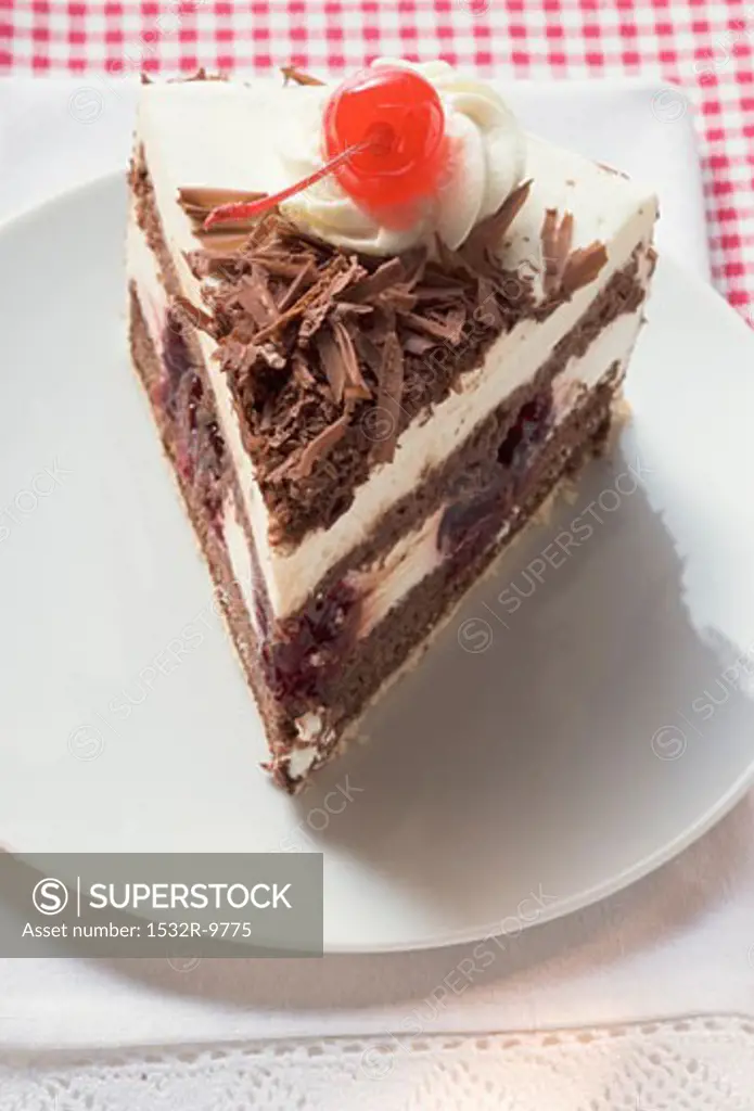 Piece of Black Forest gateau with cherry