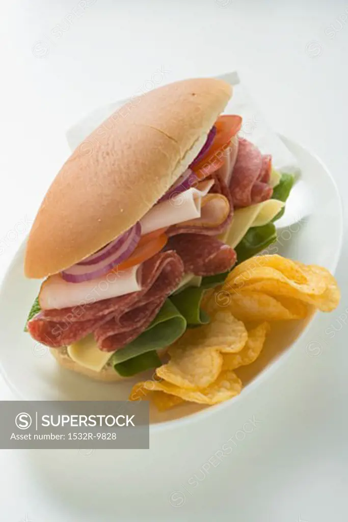 Salami, ham, cheese and salad sandwich with crisps
