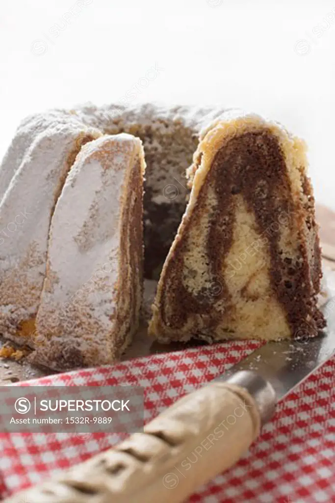 Marbled gugelhupf with icing sugar, pieces cut