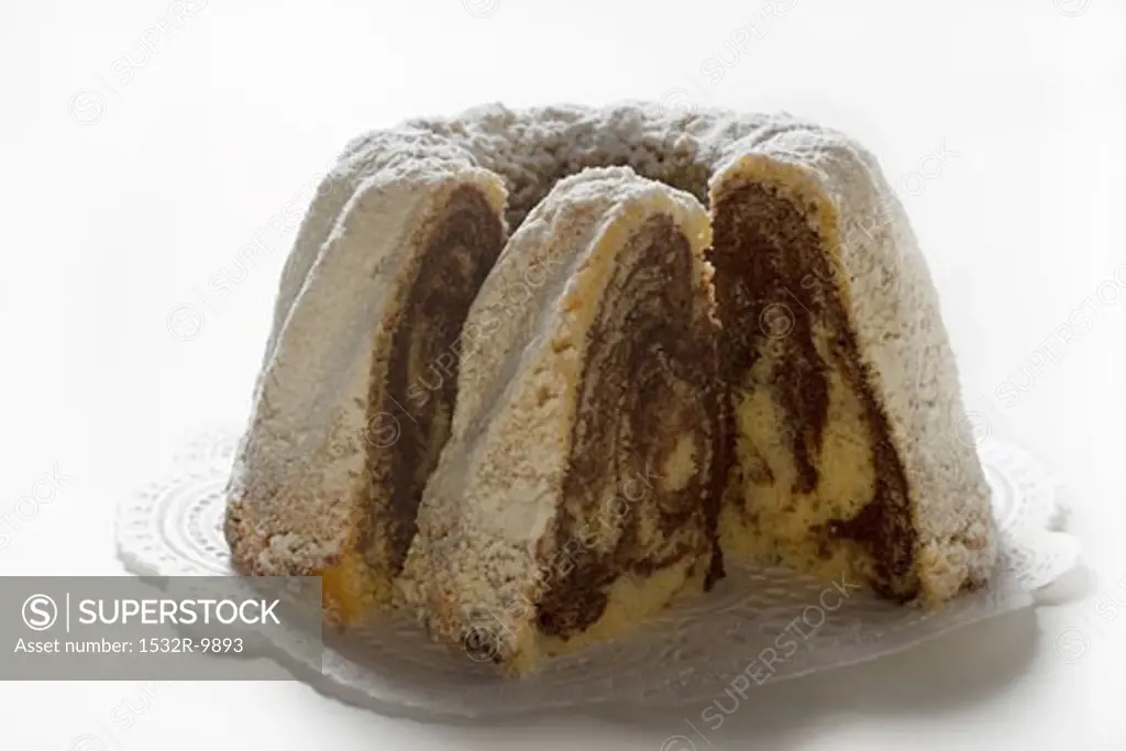 Marbled gugelhupf with icing sugar, a piece cut