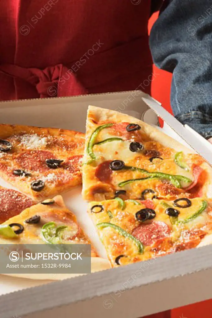 Pieces of different pizzas in pizza box