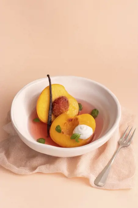 Poached Peaches in white wine, vanilla and basil
