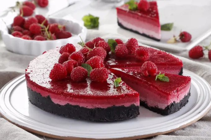 Cold ombre cheesecake with raspberries on oreo cookies
