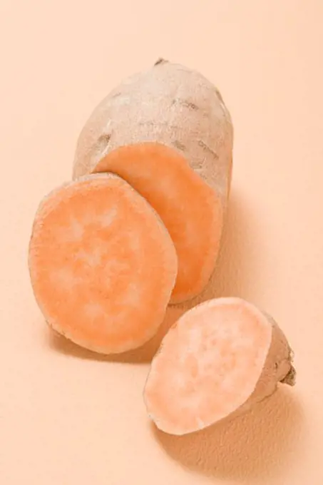 A sweet potato, partly sliced