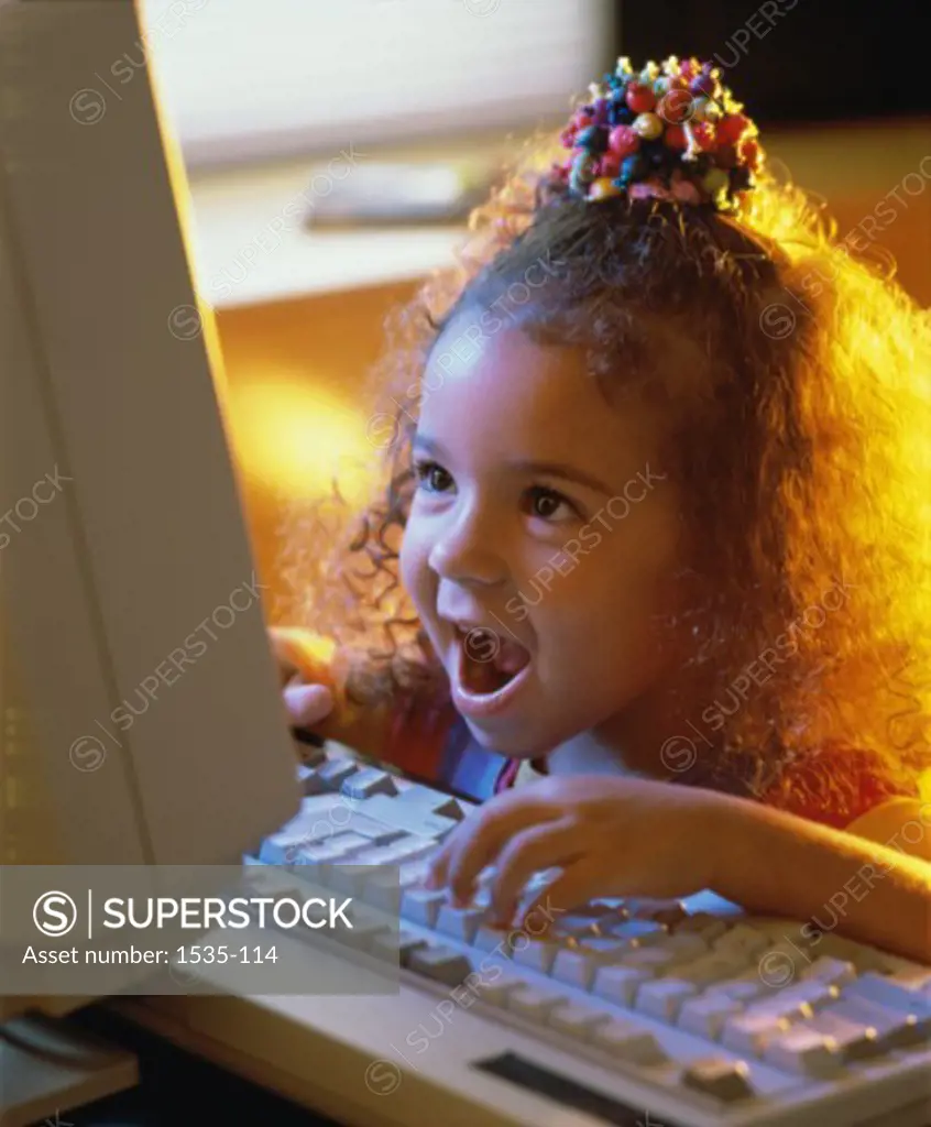 Close-up of a girl using a computer