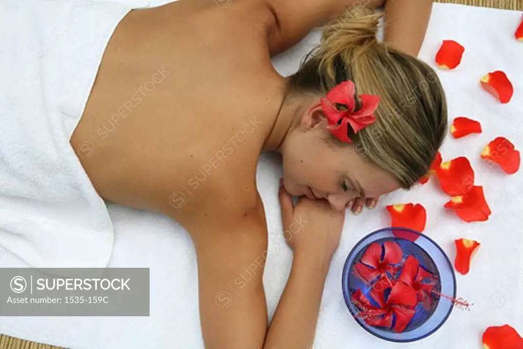 High angle view of a young woman on a massage table