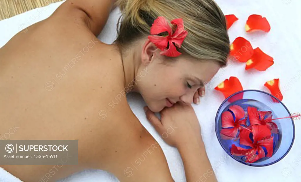 High angle view of a young woman on a massage table