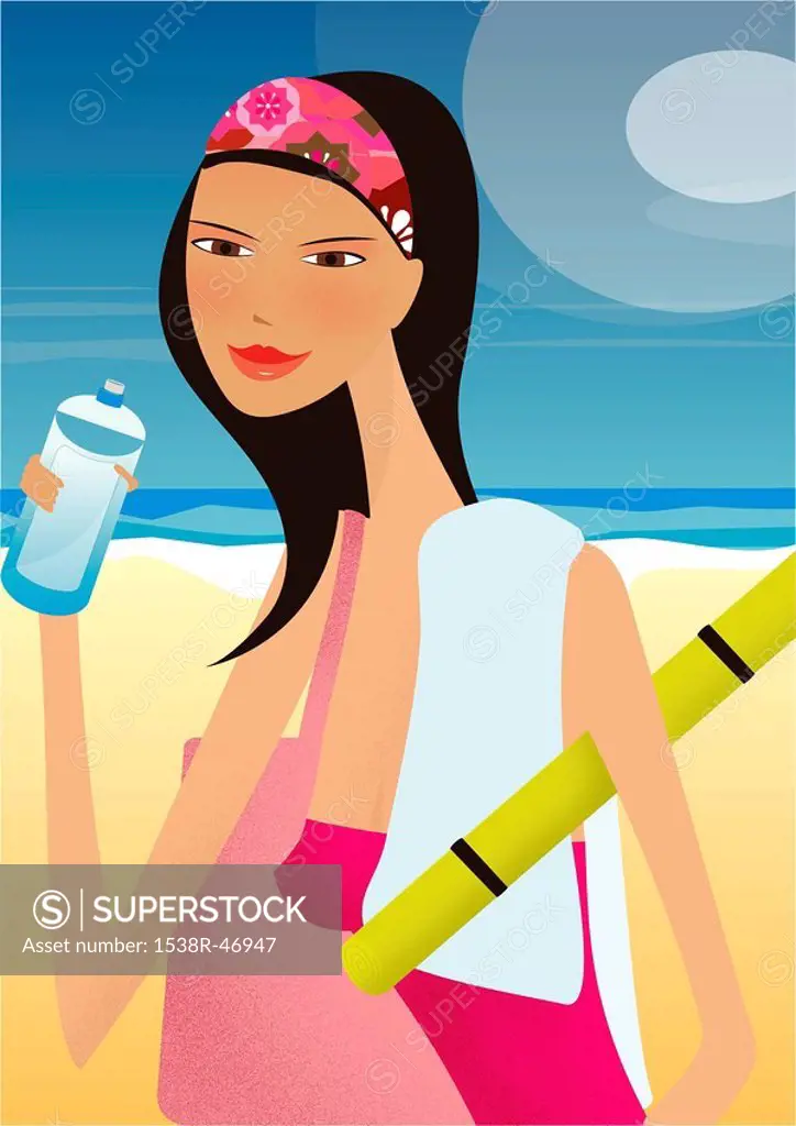 A woman drinking a bottle of water at the beach