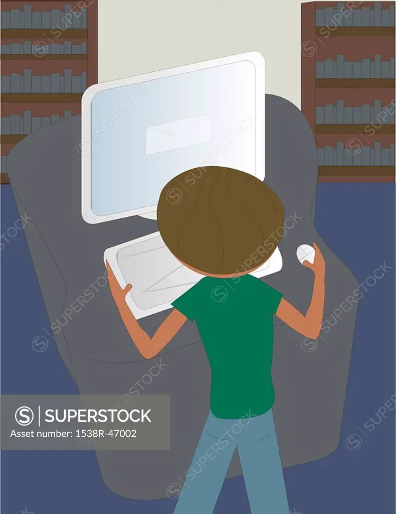 A boy using a computer at the library