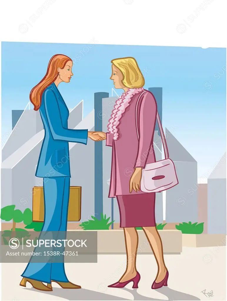 Two businesswomen shaking hands on a street