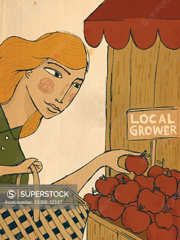 A woman picking apples from a local grower