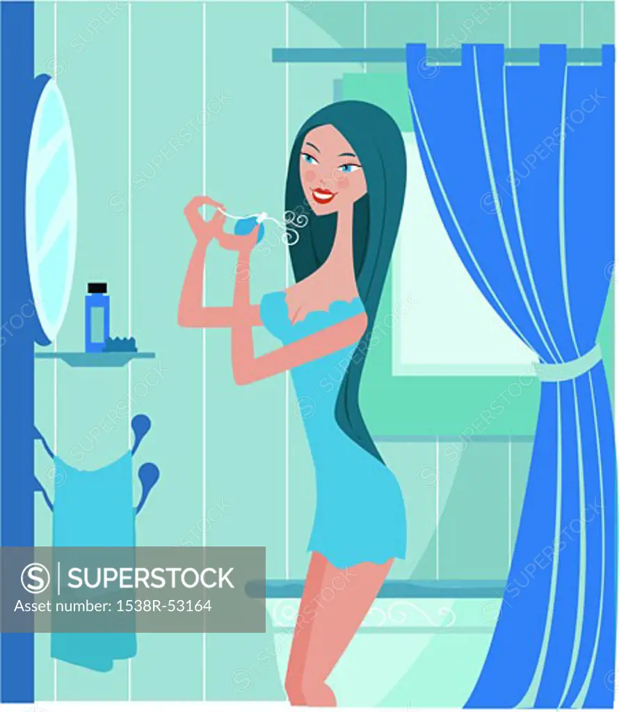 Side view of a woman in bathroom, spraying perfume on herself