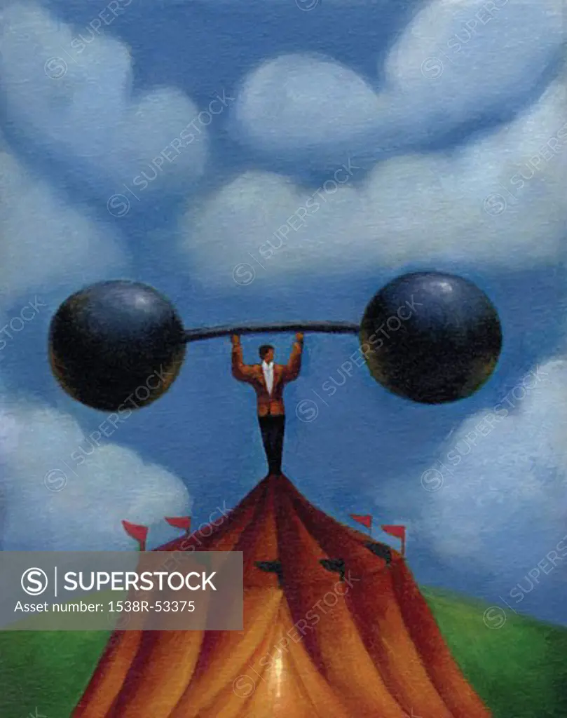 Businessman standing on top of a circus tent while holding up a barbell