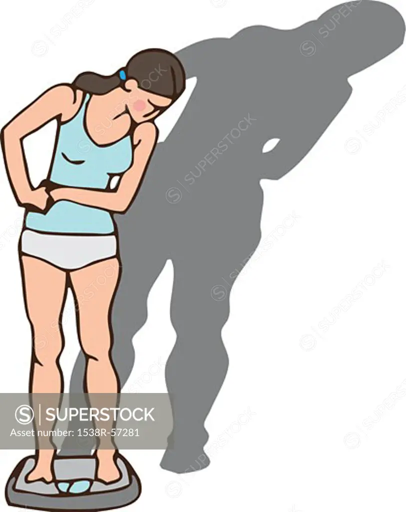 Front view of a young woman weighing herself on scales with a large shadow behind