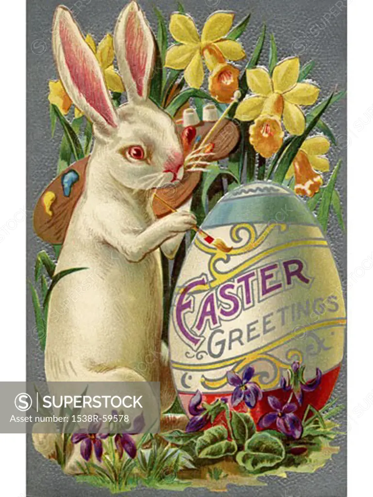 A vintage Easter postcard of a rabbit painting an egg