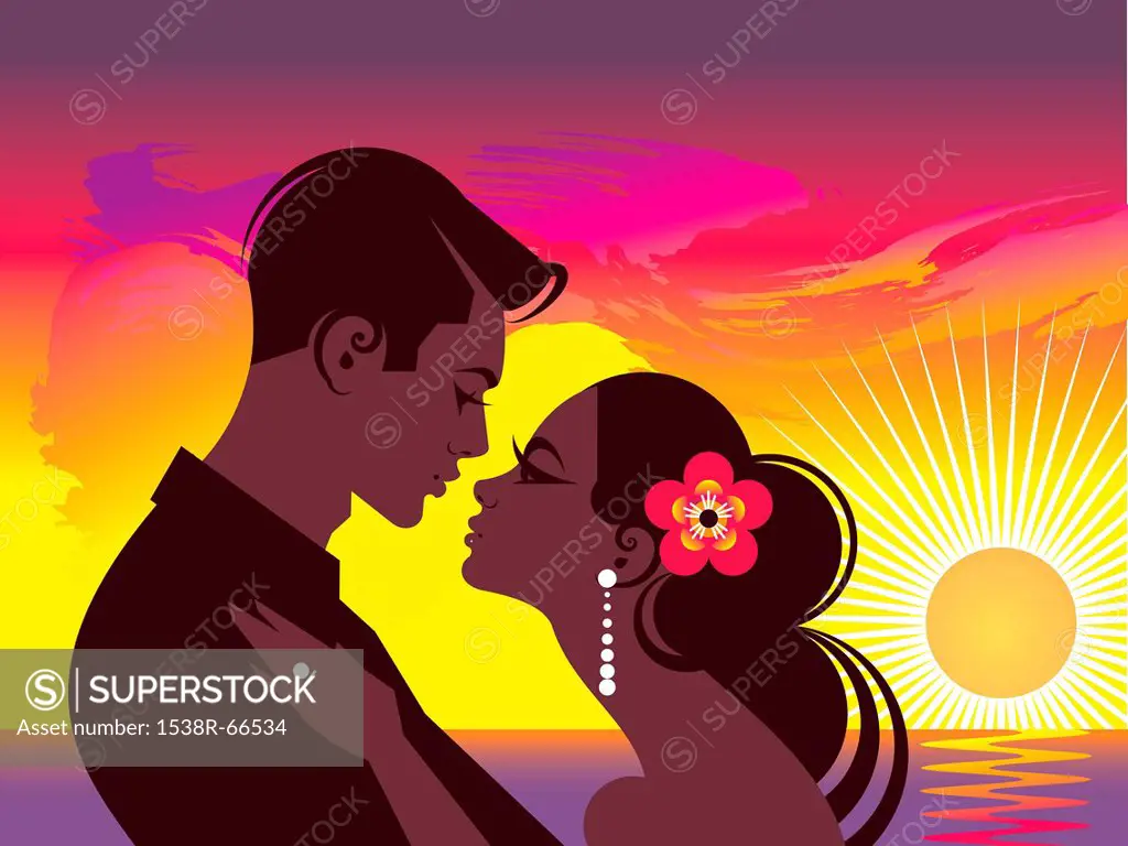A couple embracing in front of an orange sunset