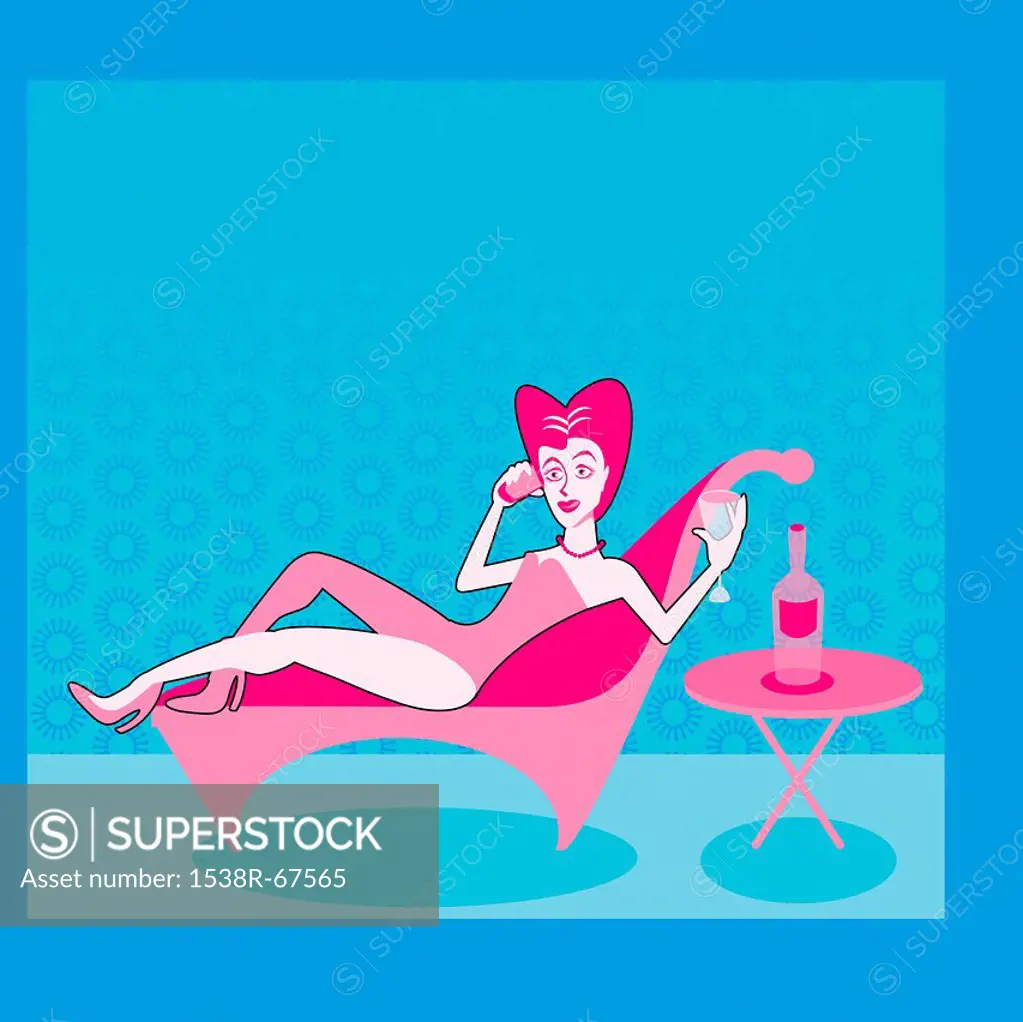 A woman talking on the telephone with a glass of champagne on a sunbed