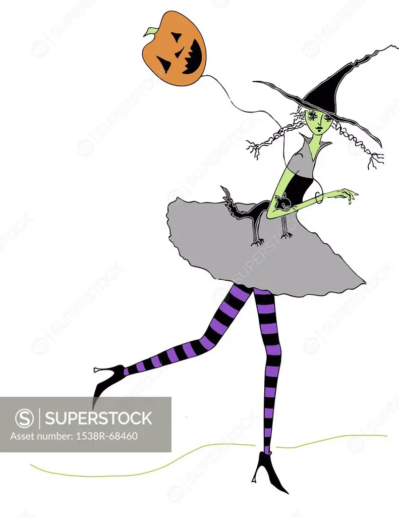 A woman dressed as a witch holding a pumpkin shaped balloon