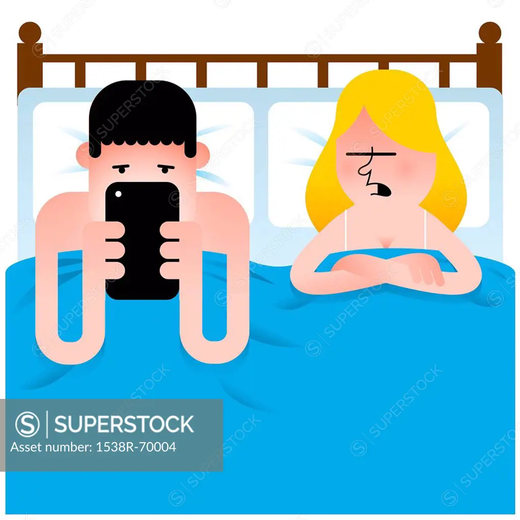 A man and woman in bed while the man is looking at a mobile device