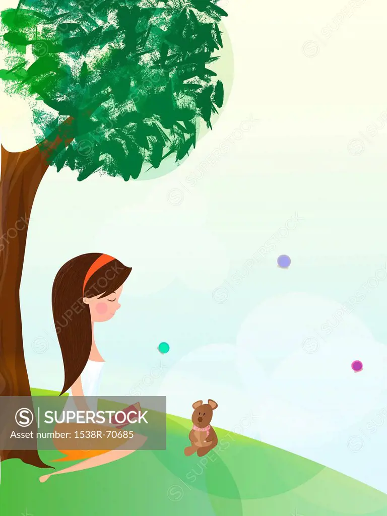 A girl sitting by a tree and reading