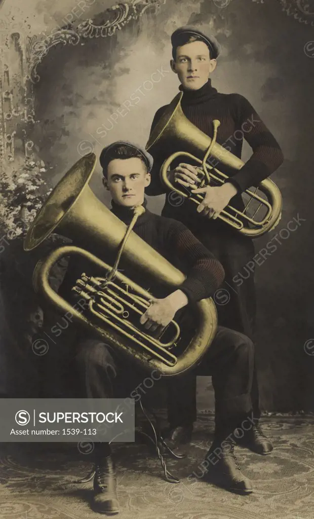 Portrait of two musicians holding tubas, c. 1907