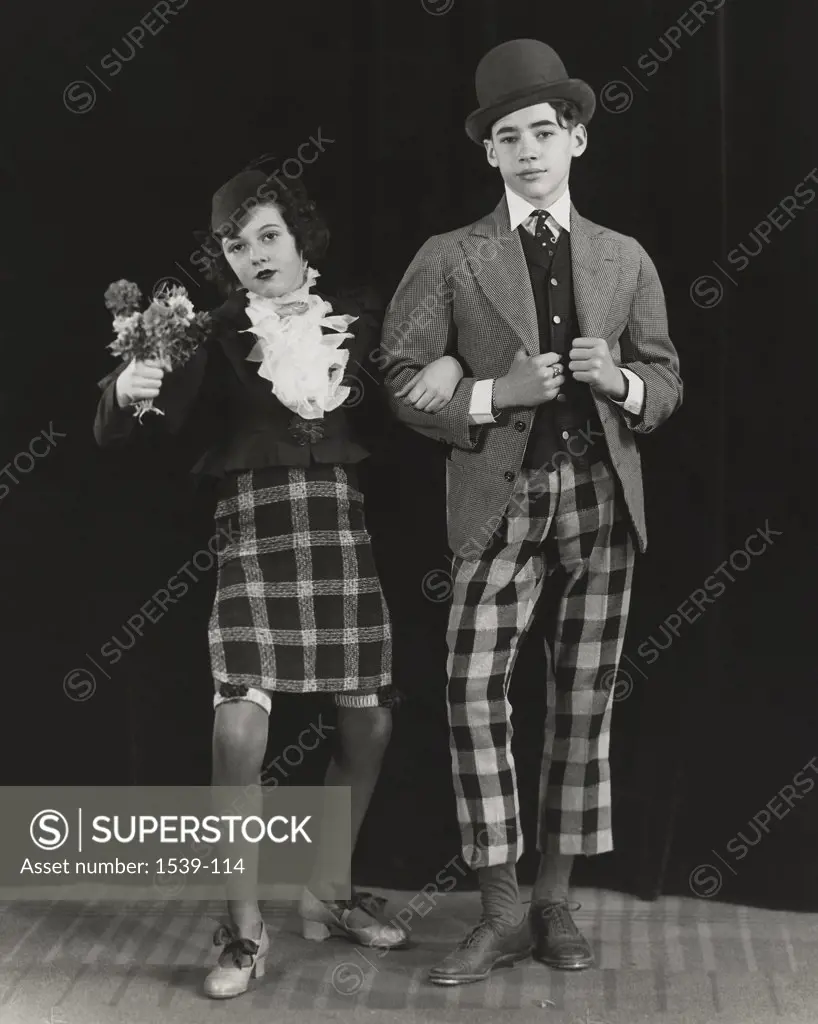Portrait of a teenage couple standing arm in arm, c. 1930
