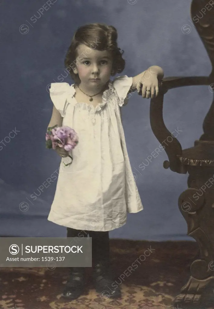 Portrait of a girl holding a bouquet of flowers, c.1900